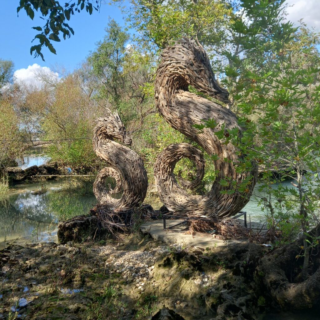 photo of wooden sculptures in front of manavgat waterfall in Antalya Turkey 